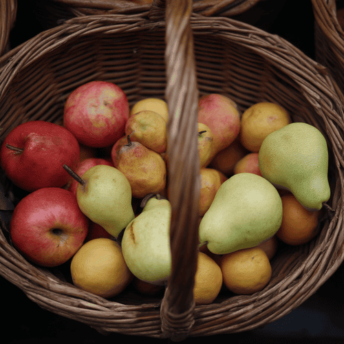 A close photo of a basket of pome fruits